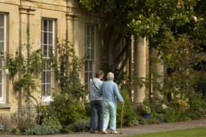 A resident and her daughter walk through the grounds at Watermoor House